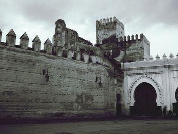 Old building against cloudy sky