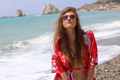 Portrait of young woman in sunglasses at beach