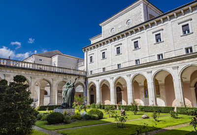 Low angle view of historic building against blue sky