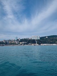 Scenic view of sea and buildings against sky