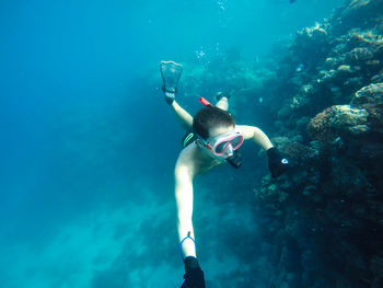Shirtless man snorkeling in sea