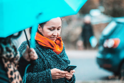 Mid adult woman using mobile phone