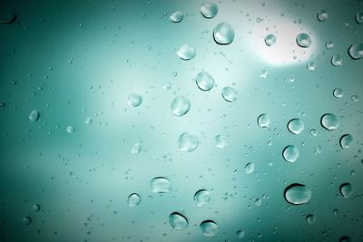 Full frame shot of raindrops on window