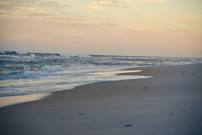 Scenic view of beach against sky during sunset