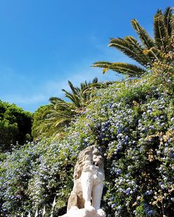 Low angle view of statue in park against sky