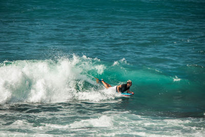 Woman surfing in sea
