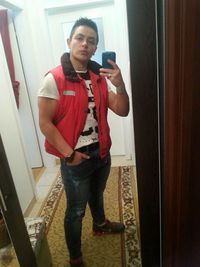 Full length of young man photographing