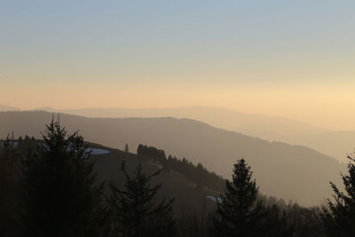 Scenic view of silhouette mountains against sky at sunset