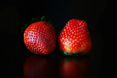 Close-up of strawberry over black background