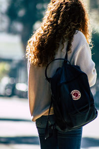 Rear view of woman standing outdoors