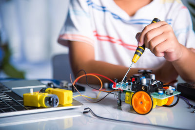 Midsection of man working on table