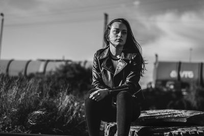 Portrait of woman sitting on field