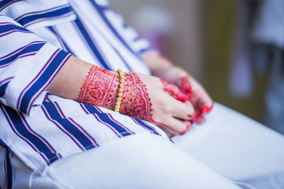 Midsection of woman with henna tattoo