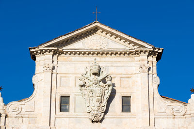 Low angle view of statue against clear blue sky