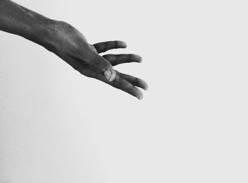 Close-up of hand against white background