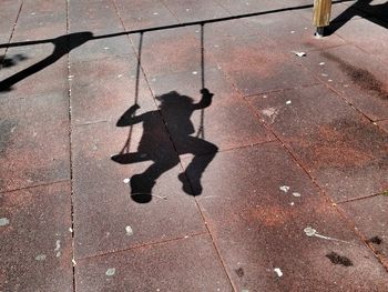 Shadow of swing on the ground