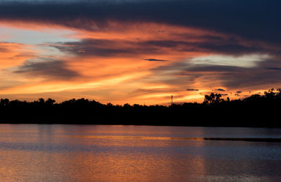 Scenic view of lake against romantic sky at sunset