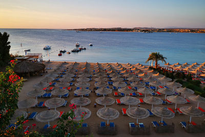 High angle view of people at beach during sunset