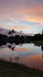 Scenic view of calm lake at sunset