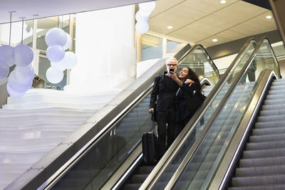 Mature couple on escalator