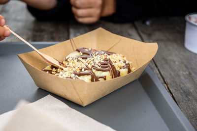 High angle view of person holding ice cream on table