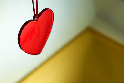 Low angle view of red light hanging on wall