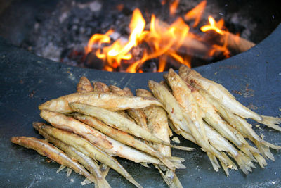 Traditional fried fish being cooked at the spring market in vilnius with fire, lithuania