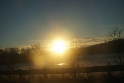 Scenic view of lake at sunset