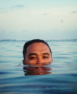 Portrait of man in infinity swimming pool