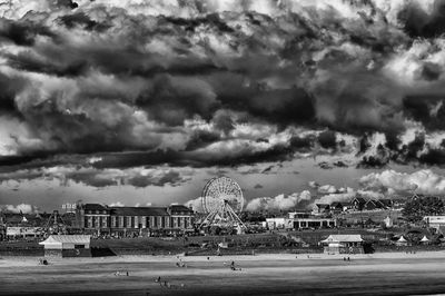 Cityscape against cloudy sky