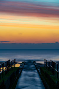 River flows into sea at sunrise