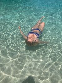 High angle view of young woman swimming in sea