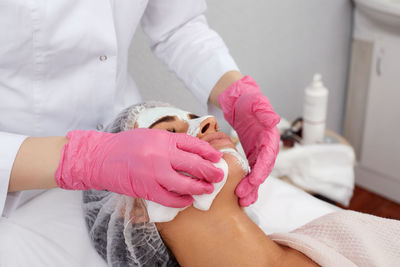 Midsection of doctor examining patient in hospital