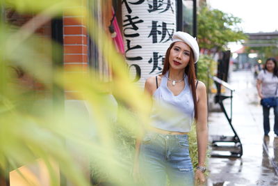 Portrait of woman standing in city