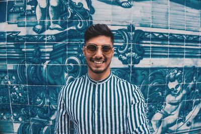 Portrait of young man wearing sunglasses standing outdoors