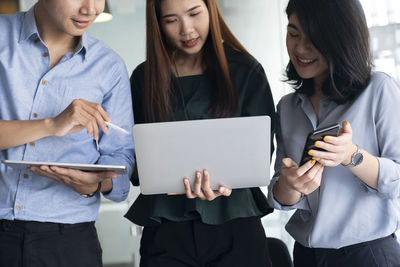 Teen group using computer and tablet to searching and learning o