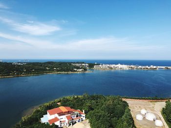 High angle view of buildings and sea against sky