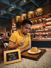 Young man having food in restaurant