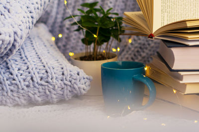 Close-up of open book on table at home