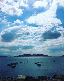 Boat in sea against cloudy sky