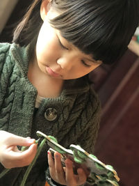 Cute girl holding decoration at home