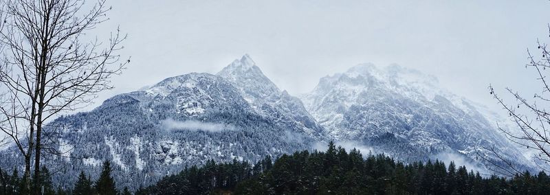 Scenic view of snow covered mountains against clear sky