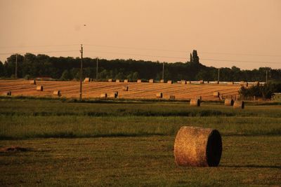 Hay bales on field against sky