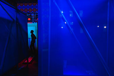 Rear view of man standing in tunnel