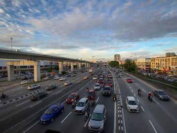 Traffic on road in city against sky