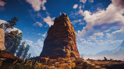 Low angle view of rock formations against sky