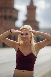 Fashionable young woman standing on street in city