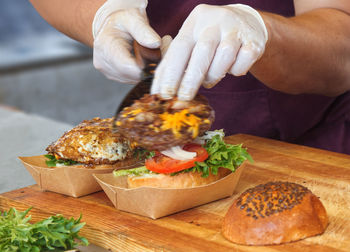Close-up of man preparing food on cutting board