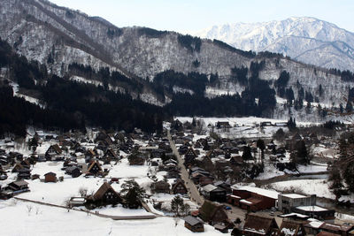 High angle view of snow covered buildings in city