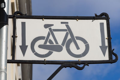 Low angle view of road sign against sky